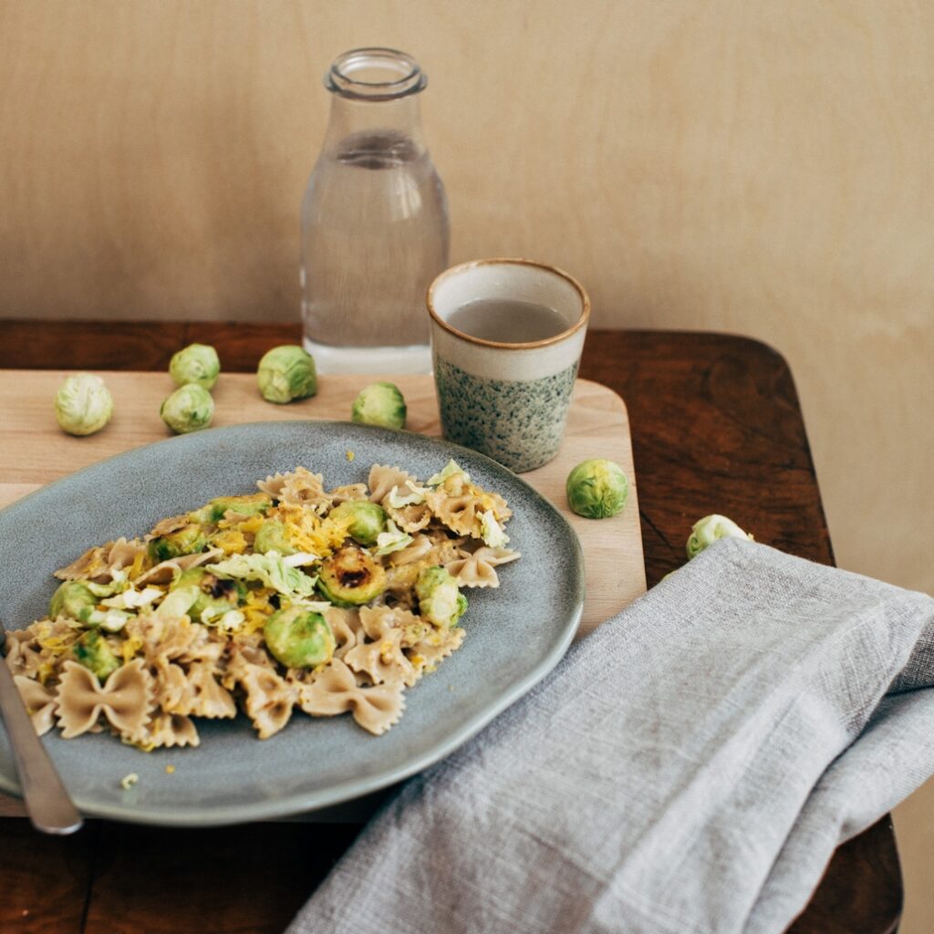 Cheese sauce pasta with brussels sprouts, lemon zest and breadcrumbs